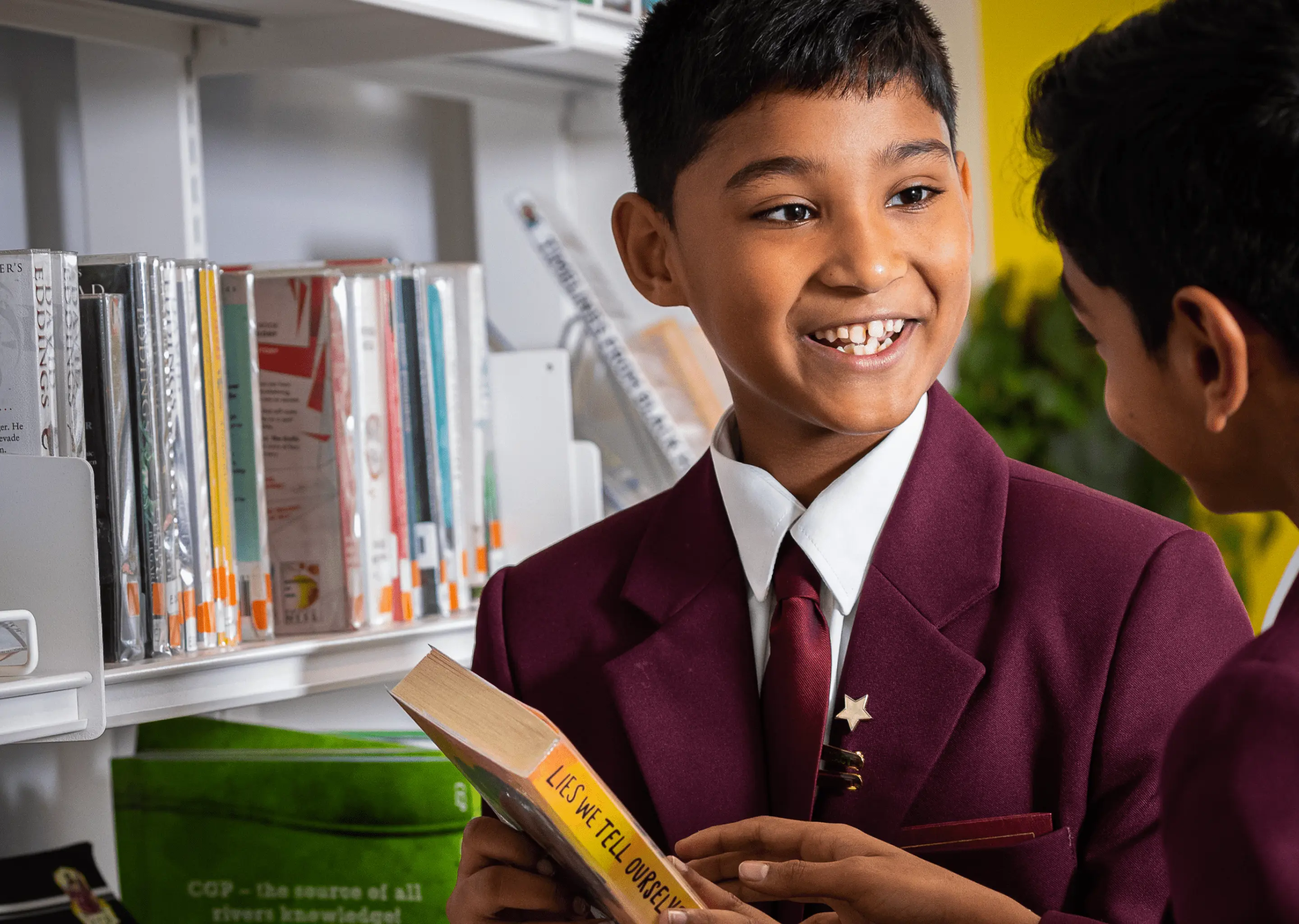 Boys in the library reading and talking about books at Homefield Prep